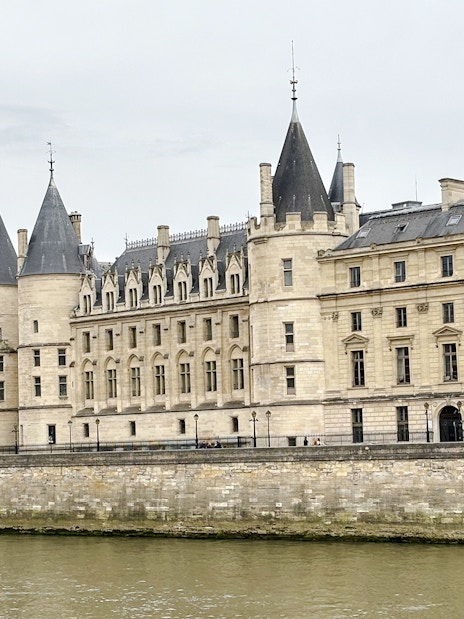 Conciergerie building along the Seine River in Paris, part of the Treasure Hunt tour from the Panthéon to the Louvre.