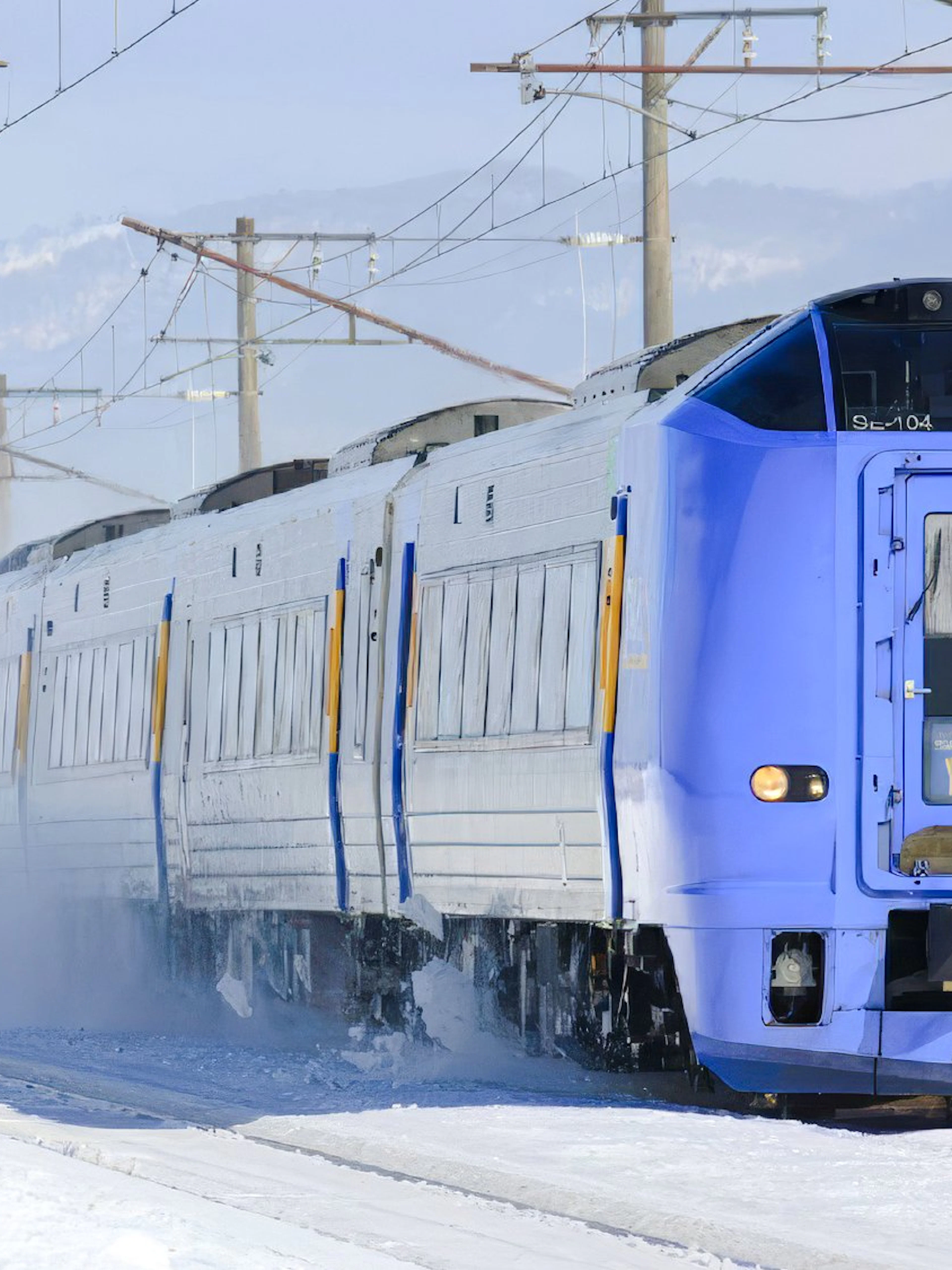 Train traveling on snowy JR Hokkaido Line in Japan.