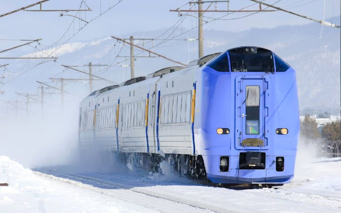 Train traveling on snowy JR Hokkaido Line in Japan.