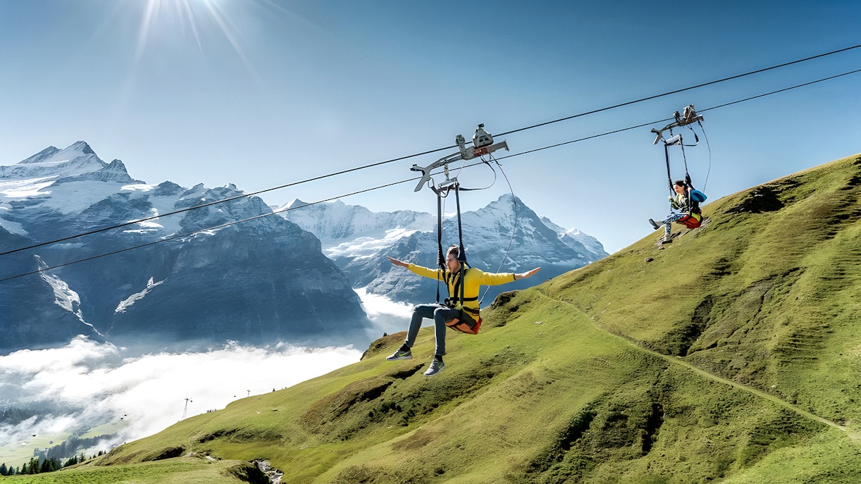 Cable car ascending to Grindelwald First with panoramic views of Swiss Alps from Lucerne.