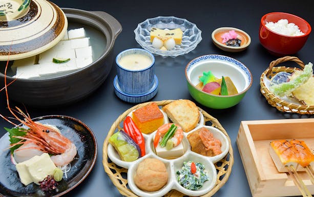 Traditional Japanese kaiseki meal with tofu, tempura, and assorted dishes in Kyoto.