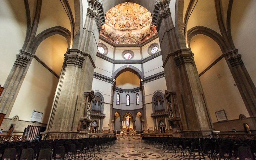 Florence Cathedral interior with frescoed dome and ornate columns.