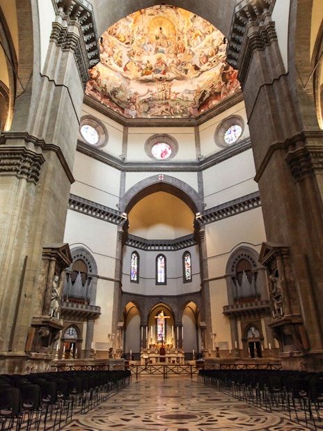 Florence Cathedral interior with frescoed dome and ornate columns.