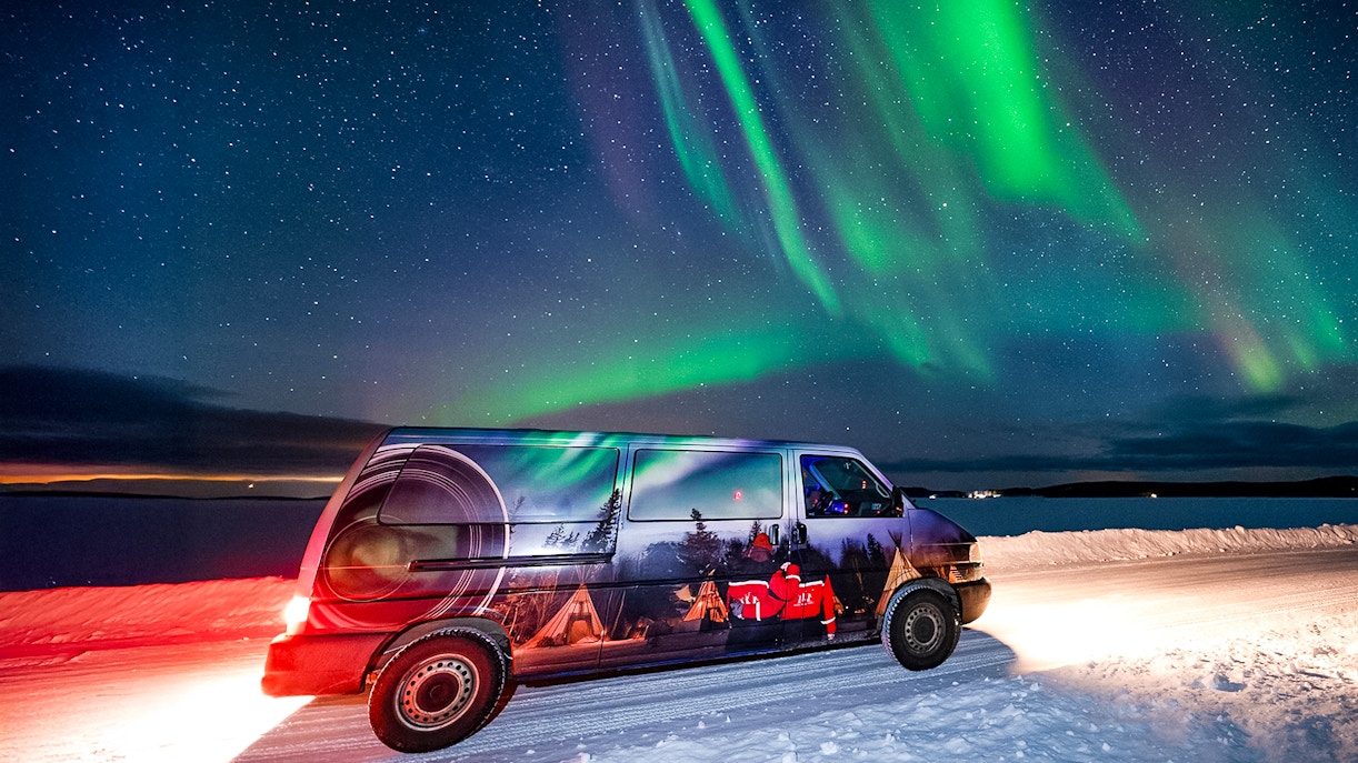 Van used for Lapland Lake Ice Floating transfers under Northern Lights.