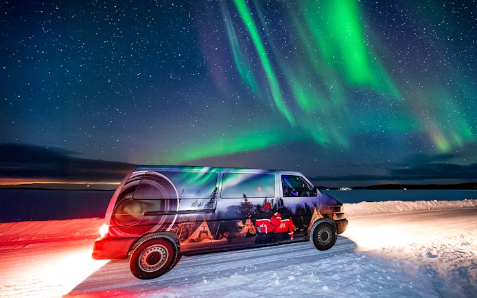 Van used for Lapland Lake Ice Floating transfers under Northern Lights.