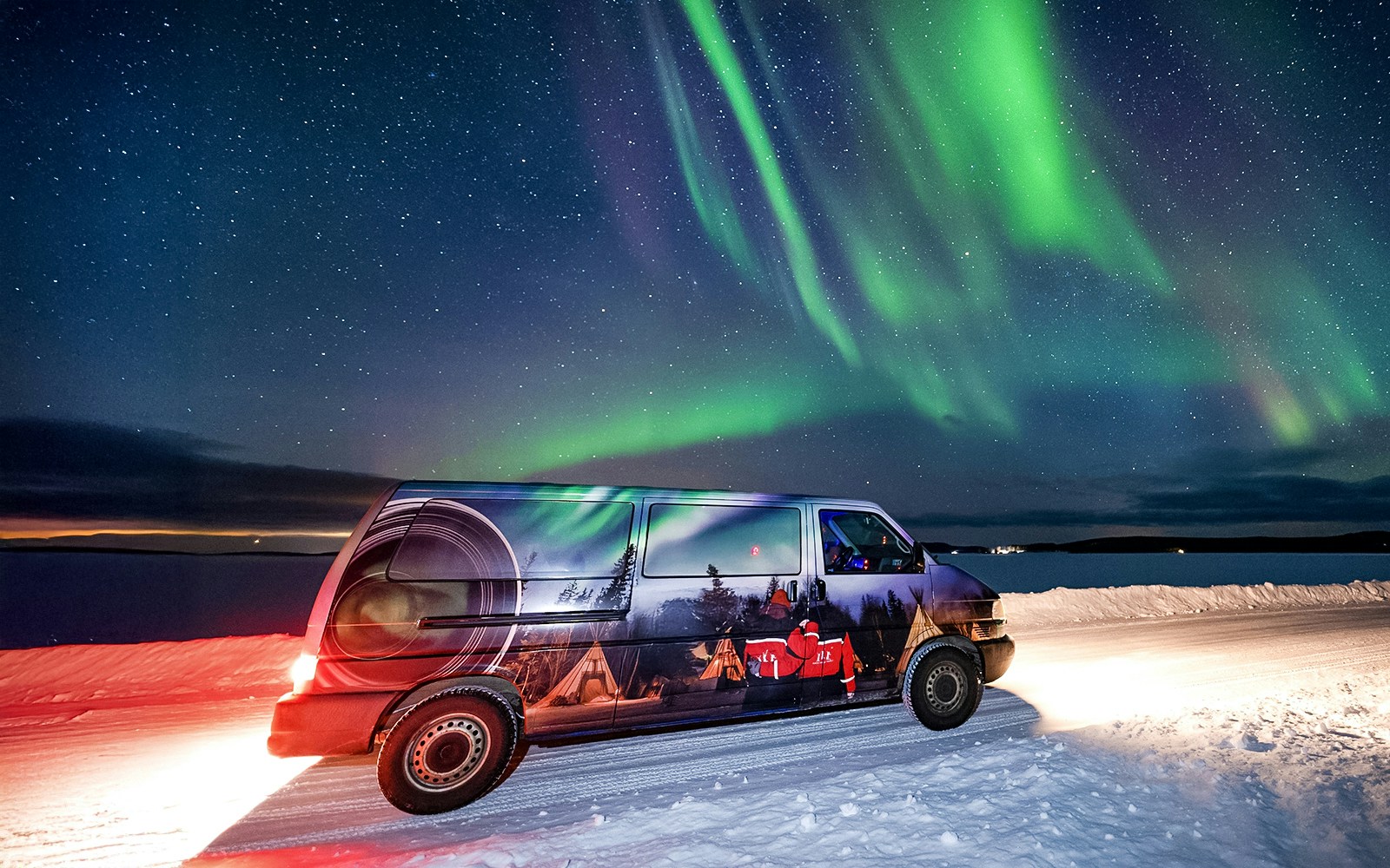 Van used for Lapland Lake Ice Floating transfers under Northern Lights.