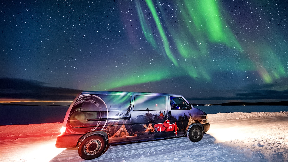 Van used for Lapland Lake Ice Floating transfers under Northern Lights.