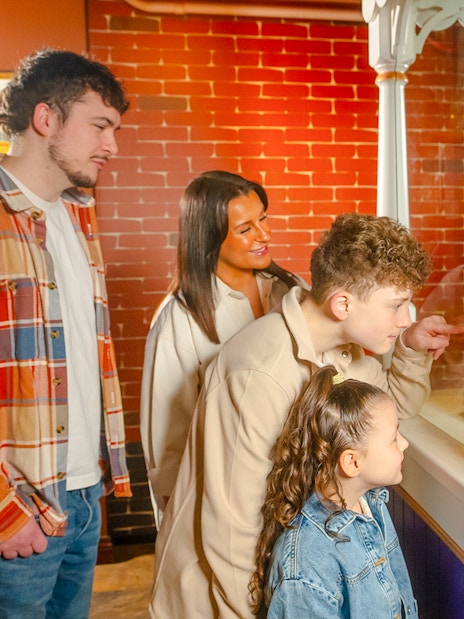 Guests viewing vintage chocolate tins at Bourneville Experience, Cadbury World.