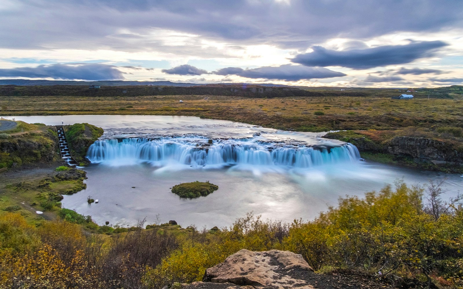 Faxi Waterfall in Iceland with lush greenery and flowing river.