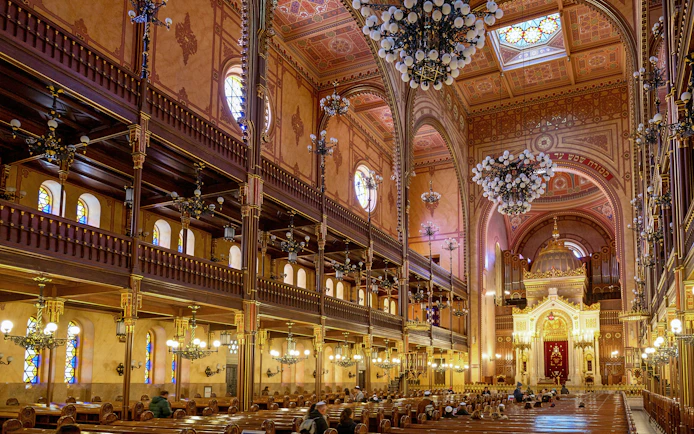 Dohany Street Synagogue interior with ornate chandeliers and stained glass windows, Budapest.