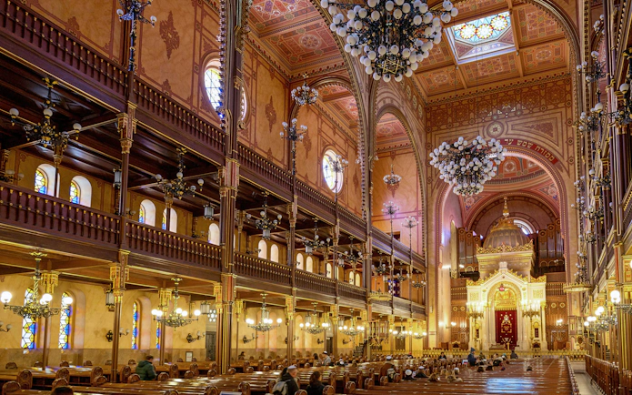 Dohany Street Synagogue interior with ornate chandeliers and stained glass windows, Budapest.