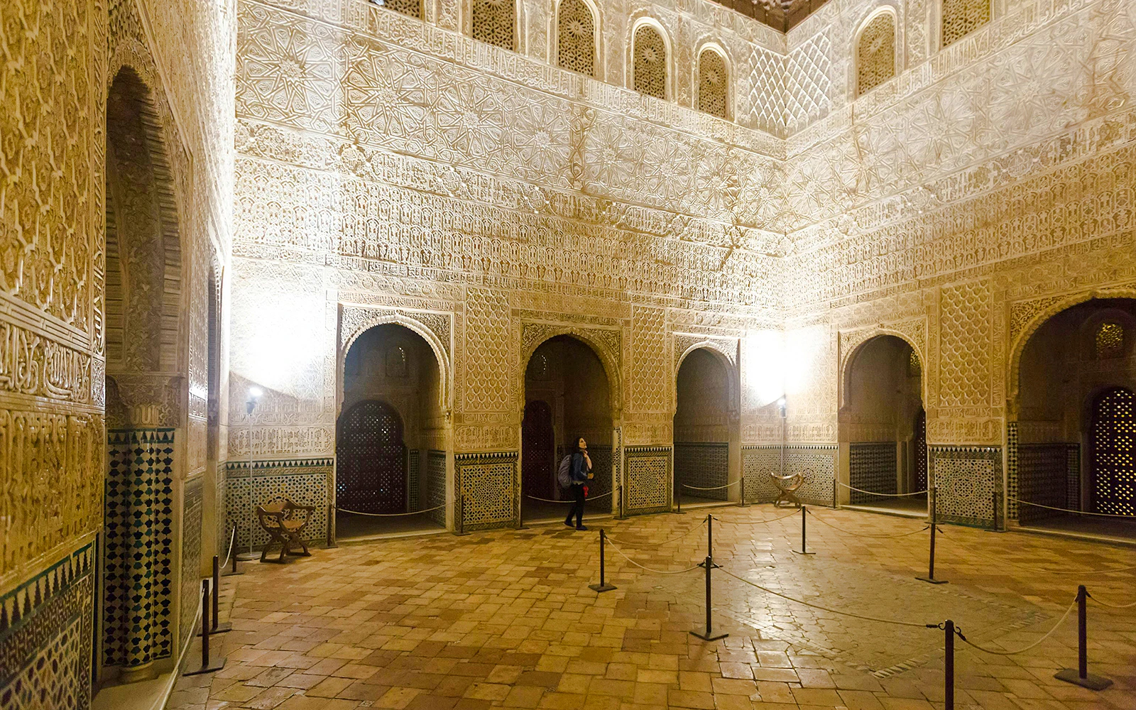 Hall of Ambassadors at the Alhambra with intricate Moorish architecture and arched doorways.