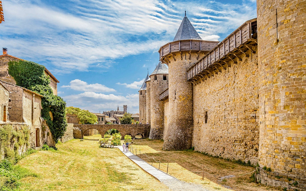 Carcassonne medieval walls and towers on walking tour path with audio guide.