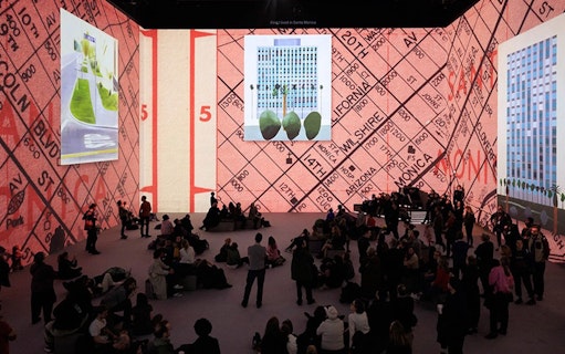David Hockney exhibition with large digital art projections and seated audience.
