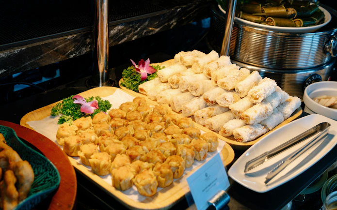 Vietnamese spring rolls and dumplings on a buffet aboard Ha Long Bay 5-Star Ambassador Cruise.