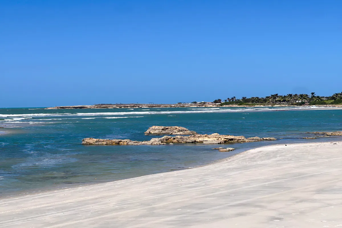 Pontal de Maceió beach with clear blue water and sandy shore, Fortim, Brazil.