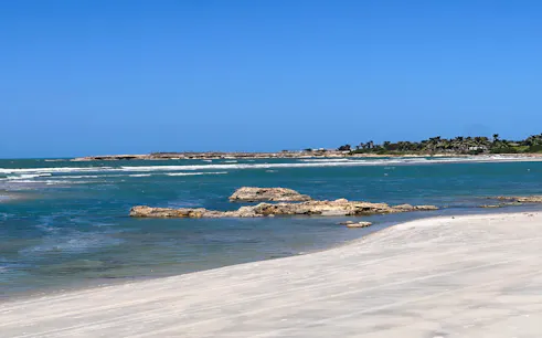 Pontal de Maceió beach with clear blue water and sandy shore, Fortim, Brazil.
