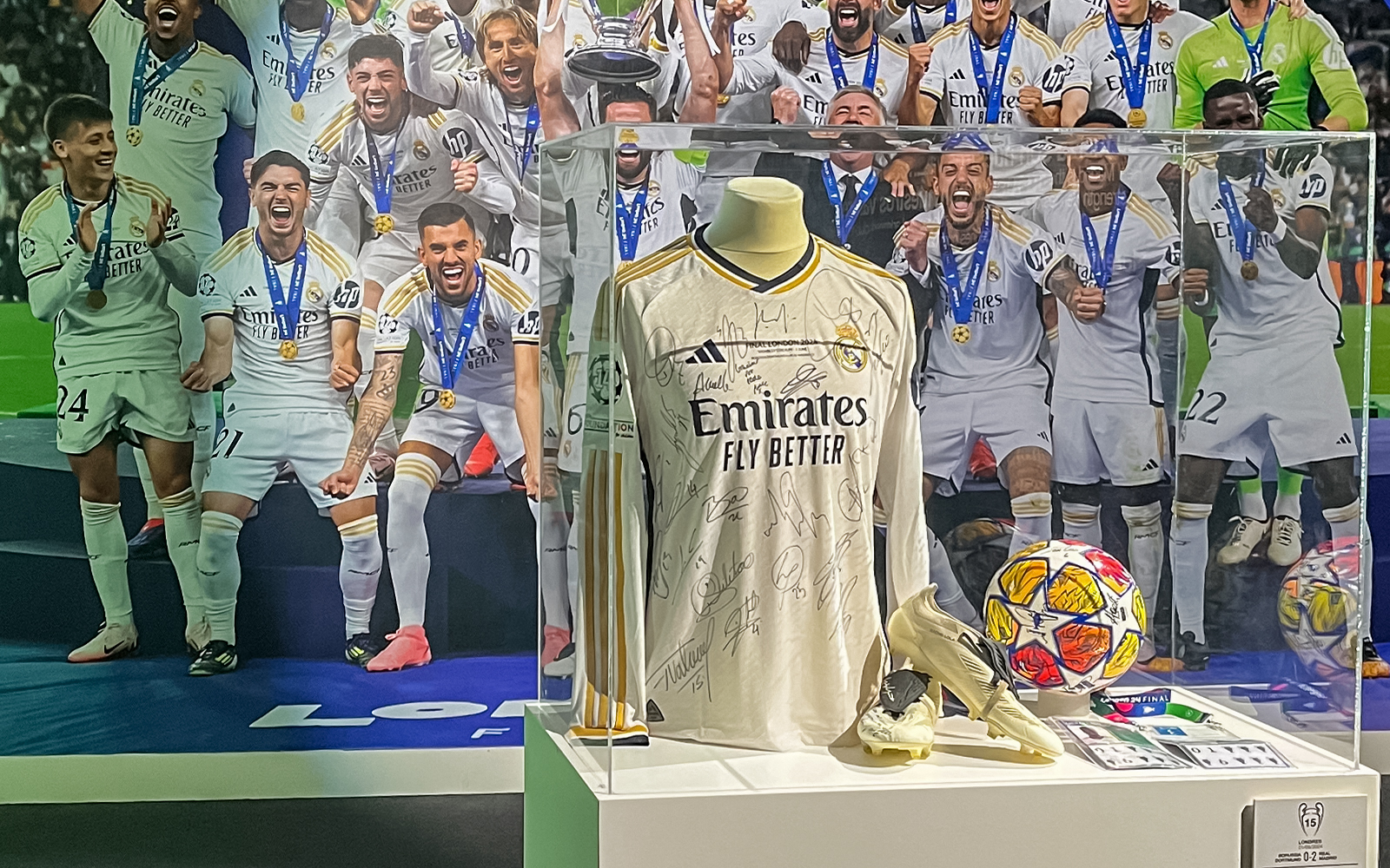 Signed Real Madrid jersey on display at Santiago Bernabeu Stadium exhibit.