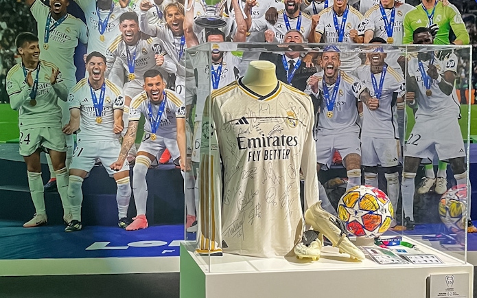 Signed Real Madrid jersey on display at Santiago Bernabeu Stadium exhibit.
