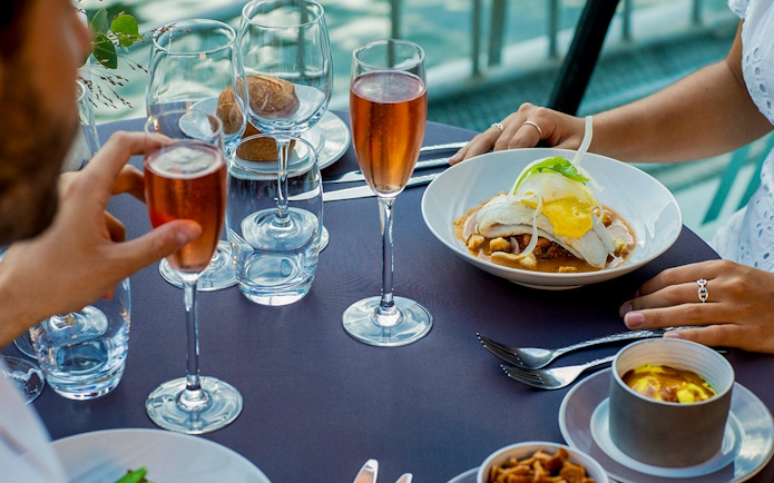 Dinner setting on a Seine River cruise with gourmet dishes and champagne at 6:15pm.