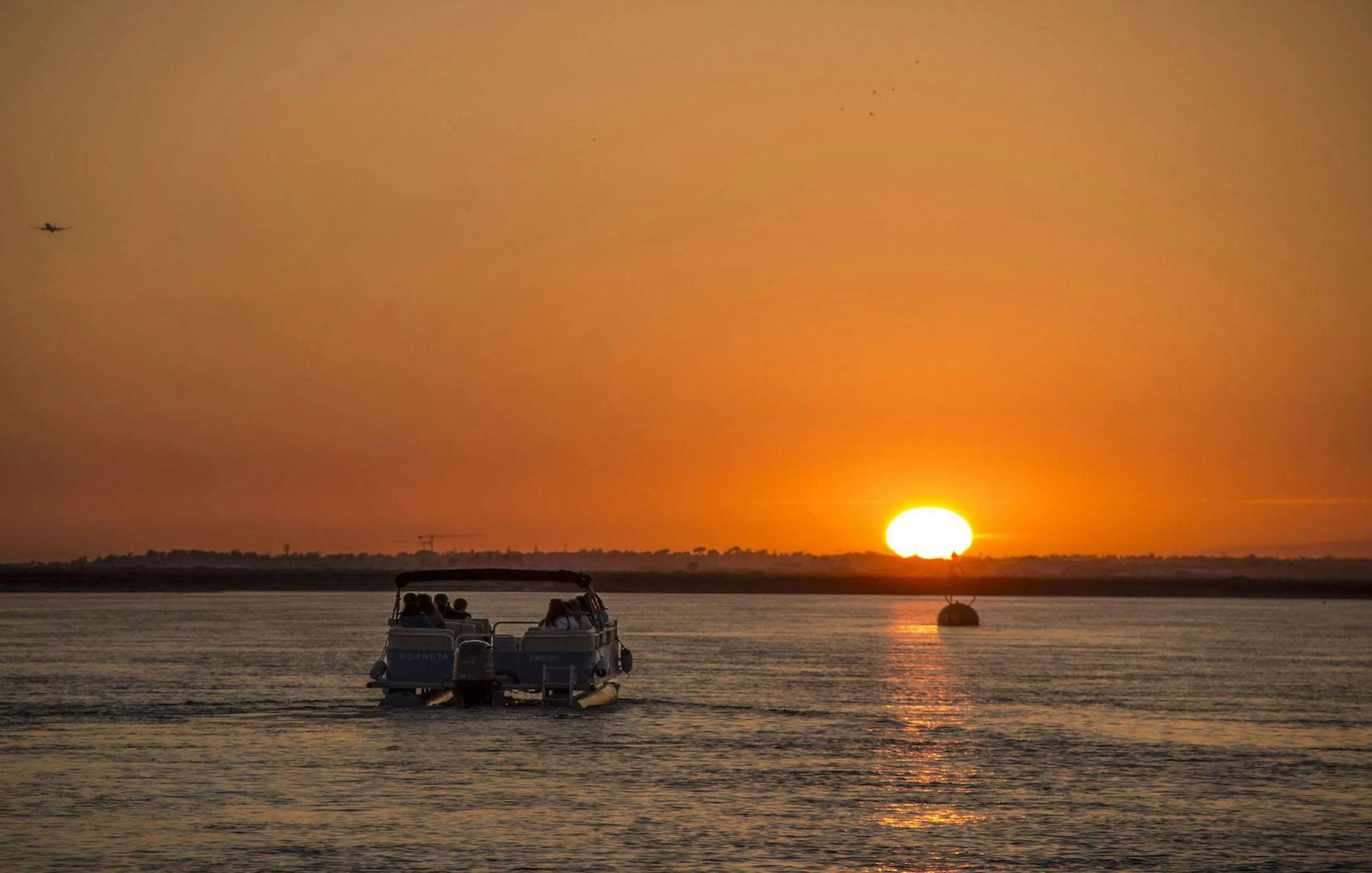 Boat cruising during sunset in Ria Formosa, Portugal.