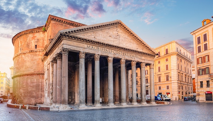 Roman Pantheon exterior with tourists using audio guides in Rome, Italy.