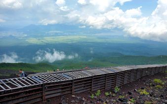 Climbers ascending Mt. Fuji with expansive views of the surrounding landscape.