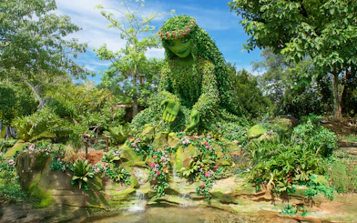 Giant green sculpture inspired by Moana surrounded by lush plants at Walt Disney Resort Orlando.