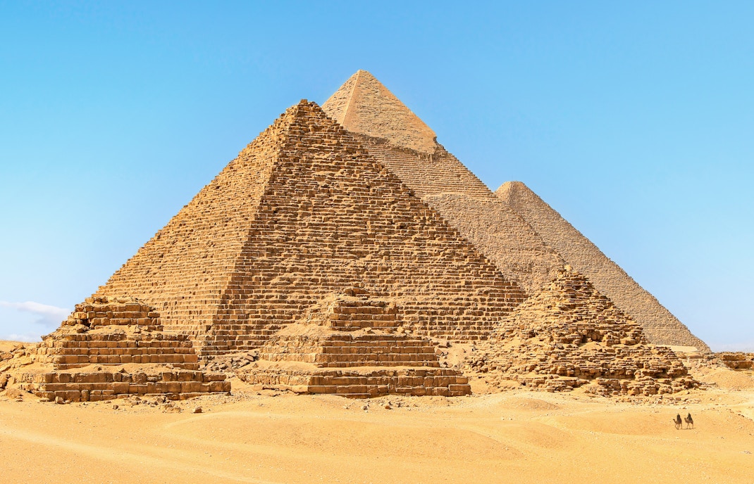Pyramids of Giza in Egypt under a clear blue sky.