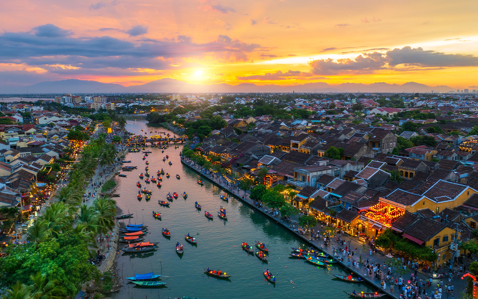 Lantern boats on the river at sunset in Hoi An, Vietnam, Quang Nam Province.