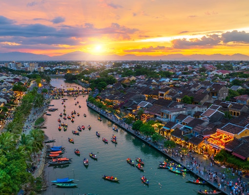 Lantern boats on the river at sunset in Hoi An, Vietnam, Quang Nam Province.