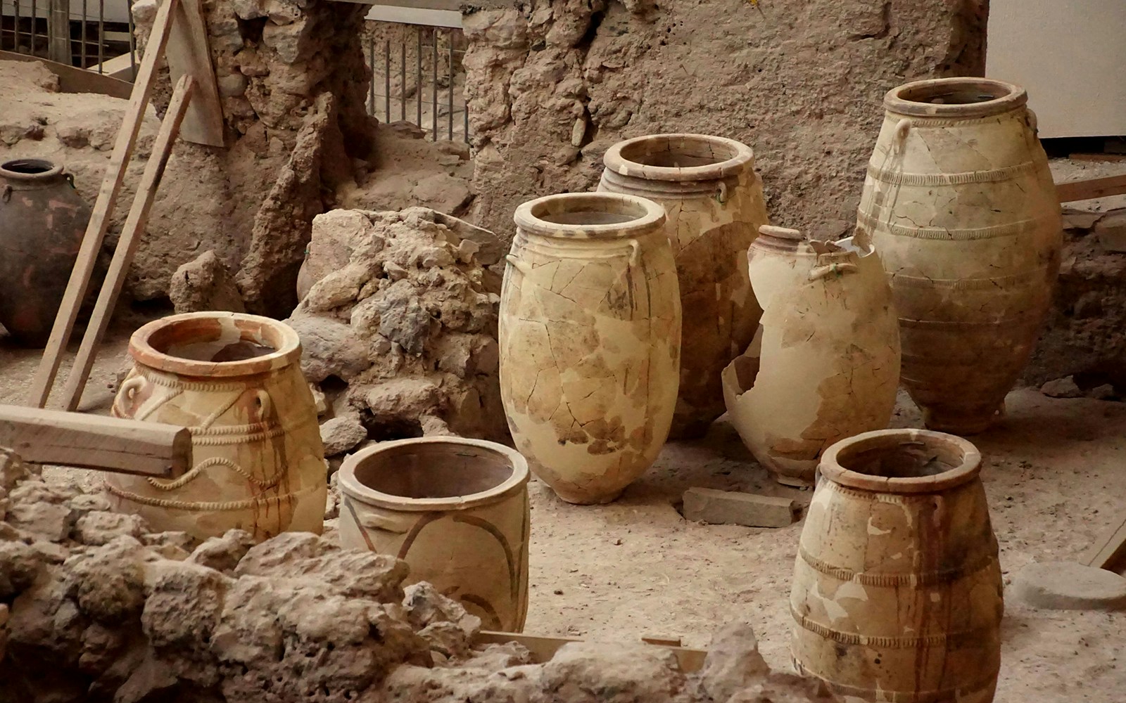 Ancient pottery jars at Akrotiri archaeological site in Santorini.