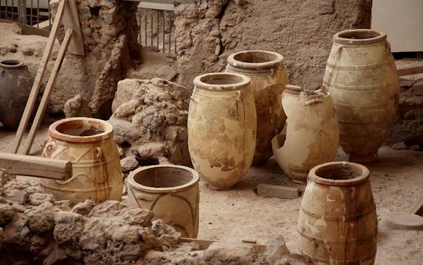Ancient pottery jars at Akrotiri archaeological site in Santorini.