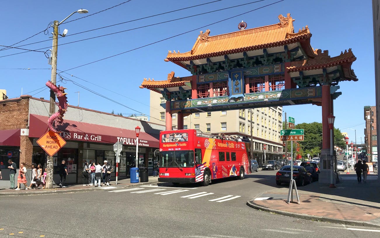 Seattle City Sightseeing bus under Chinatown gate on 5th Ave.