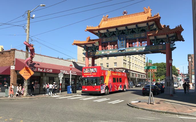 Seattle City Sightseeing bus under Chinatown gate on 5th Ave.