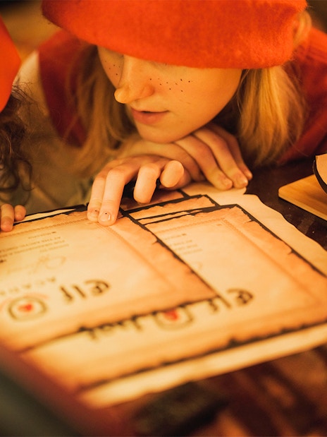 Children writing certificates at Elf Hat Academy in Santa's Village.
