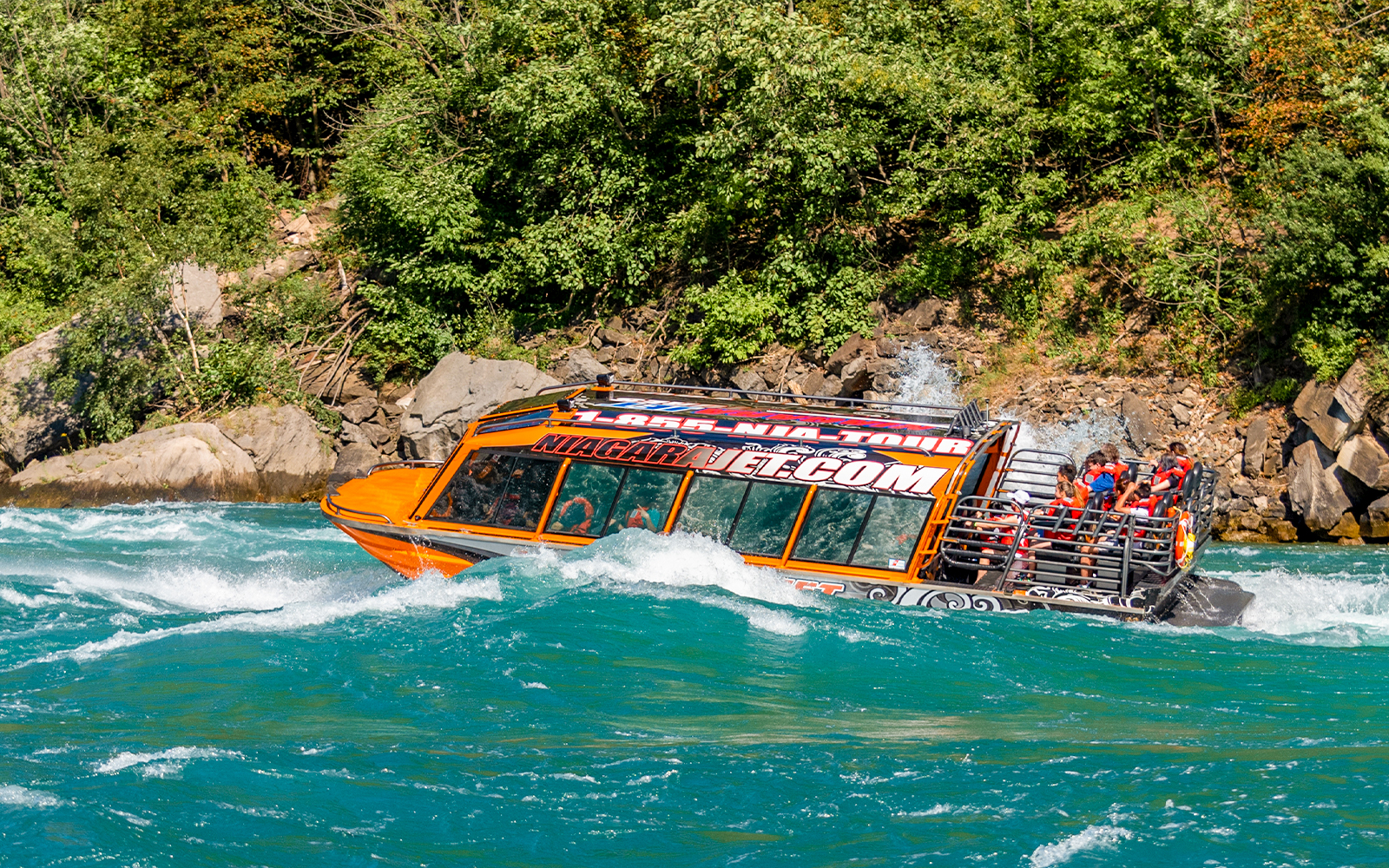 Niagara River jet boat navigating rapids near Niagara Falls.