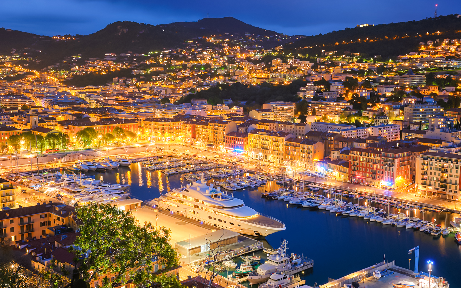 Villefranche-sur-Mer harbor illuminated at night during New Year in Nice.