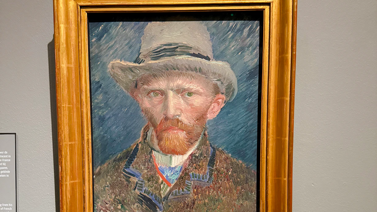 Self-portrait by Vincent van Gogh, 1887, featuring the artist in a hat with a textured background.