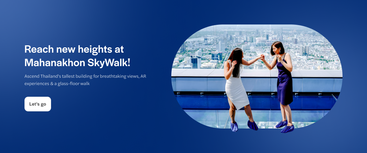 Women walking on glass floor at Mahanakhon SkyWalk, Bangkok, with city view.