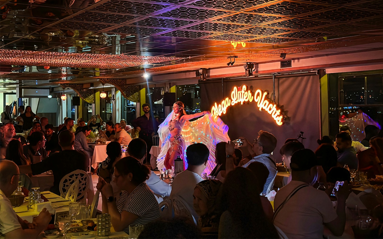 Bosphorus dinner cruise with Turkish show, private table, and cityscape view in Istanbul.