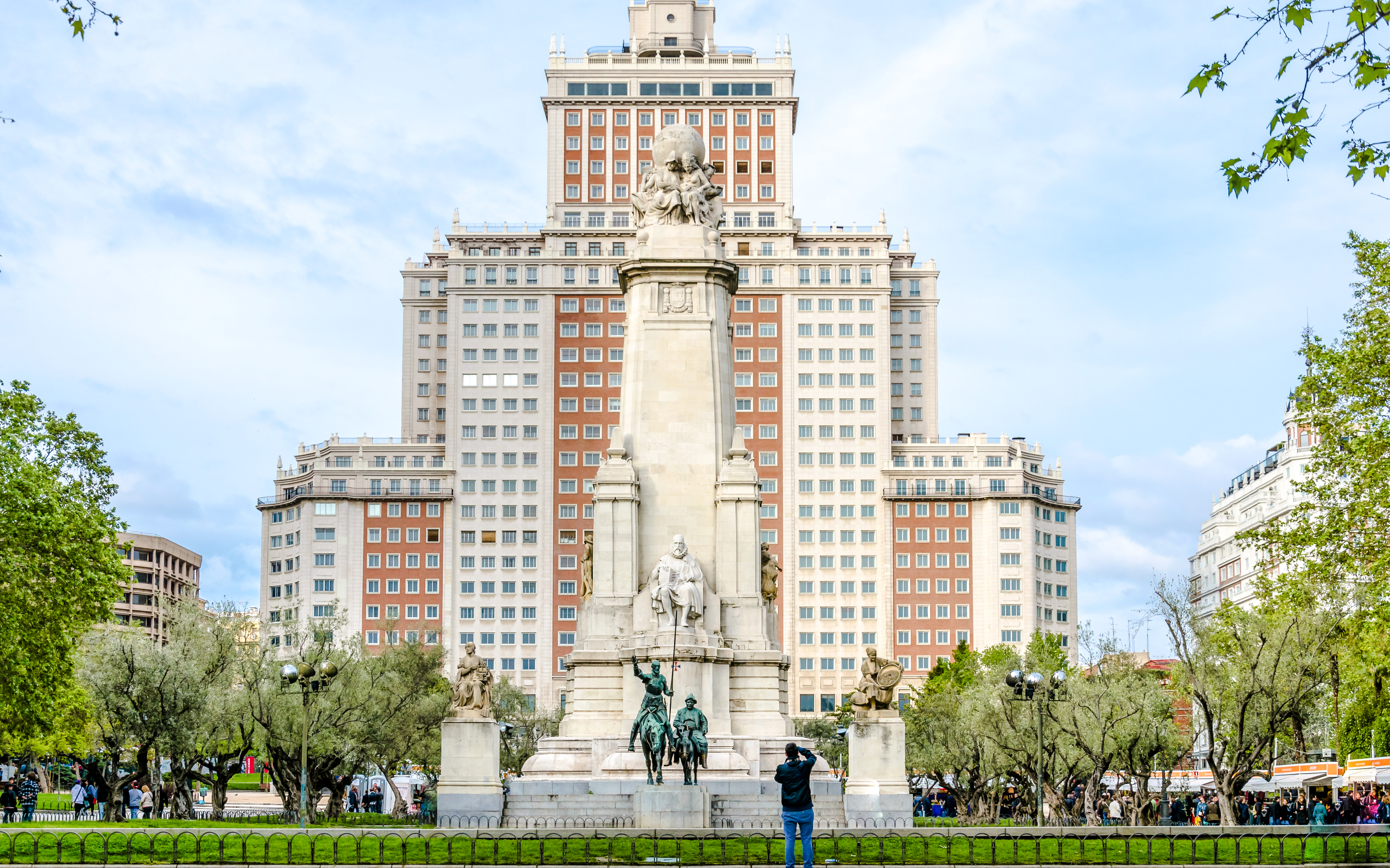 Monument to Cervantes at Plaza de España, Madrid, with Torre de Madrid in the background.