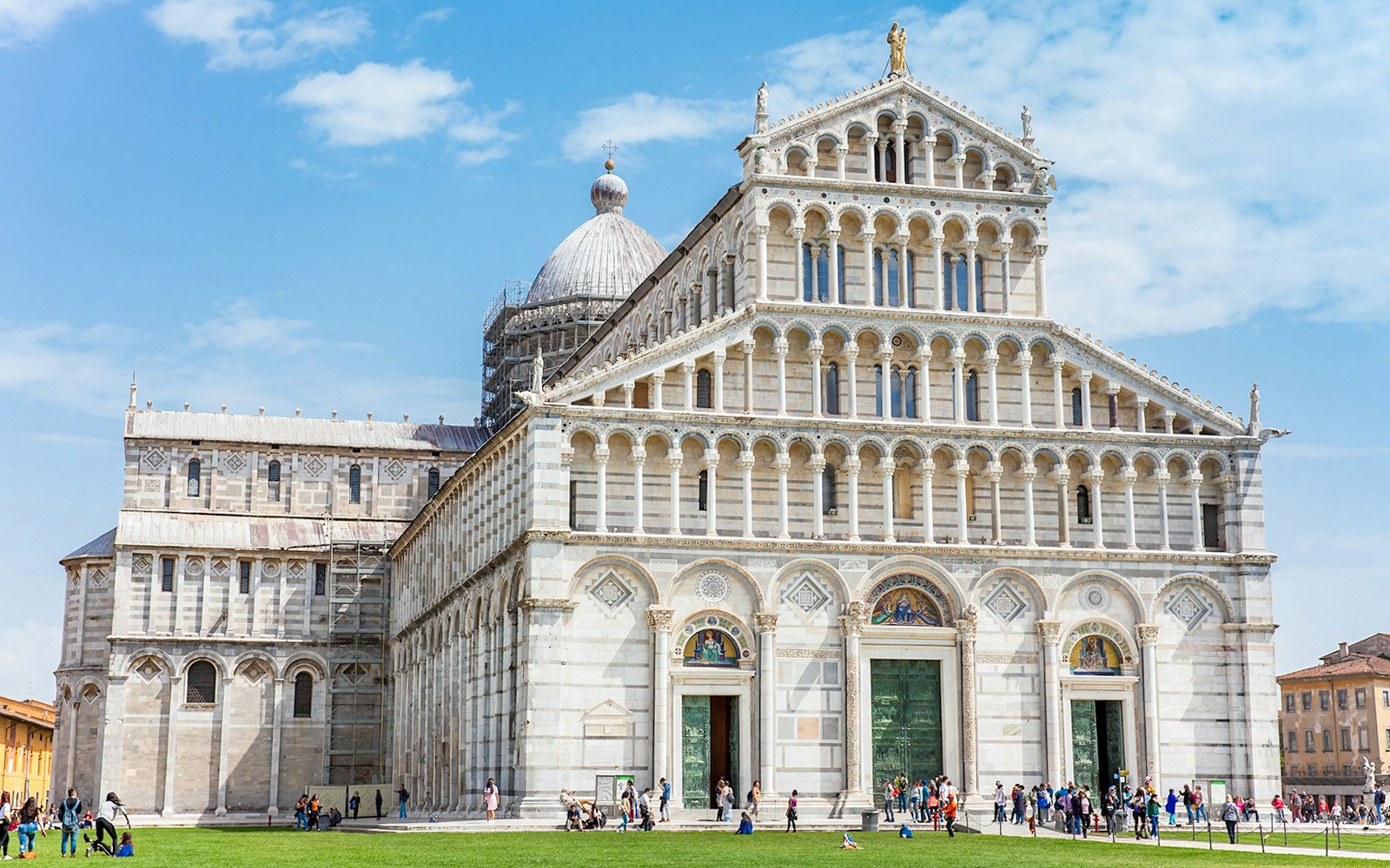 Pisa Cathedral in the Square of Miracles, Pisa, with visitors exploring the site.