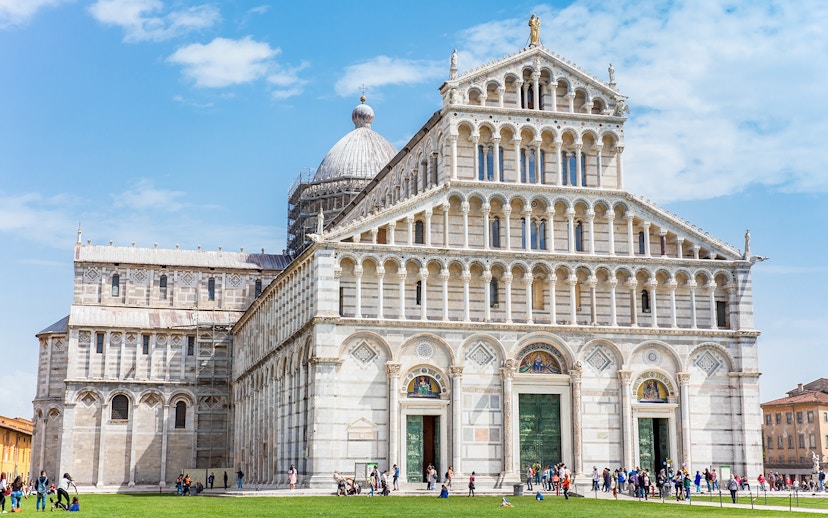 Pisa Cathedral in the Square of Miracles, Pisa, with visitors exploring the site.