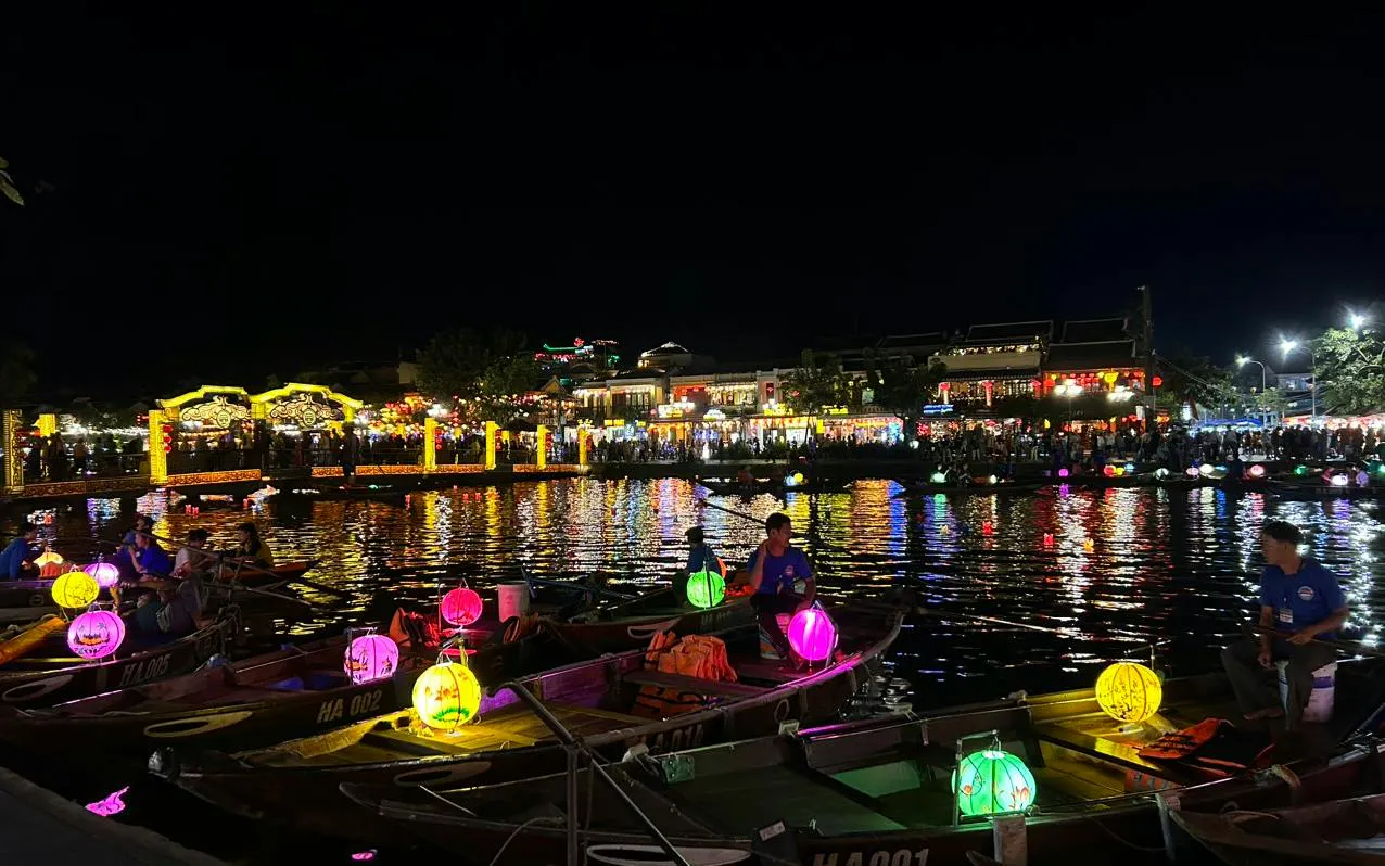 Boat ride with colorful lanterns and free herbal drink in Dubai at night.