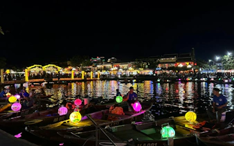 Boat ride with colorful lanterns and free herbal drink in Dubai at night.