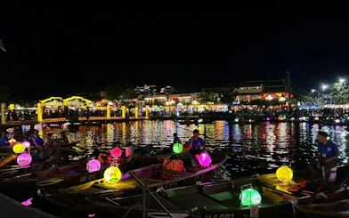 Boat ride with colorful lanterns and free herbal drink in Dubai at night.