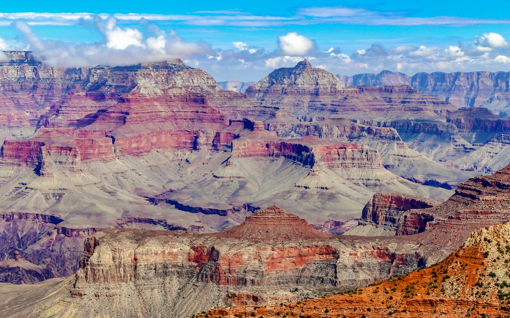 Grand Canyon's layered rock formations under a clear blue sky.