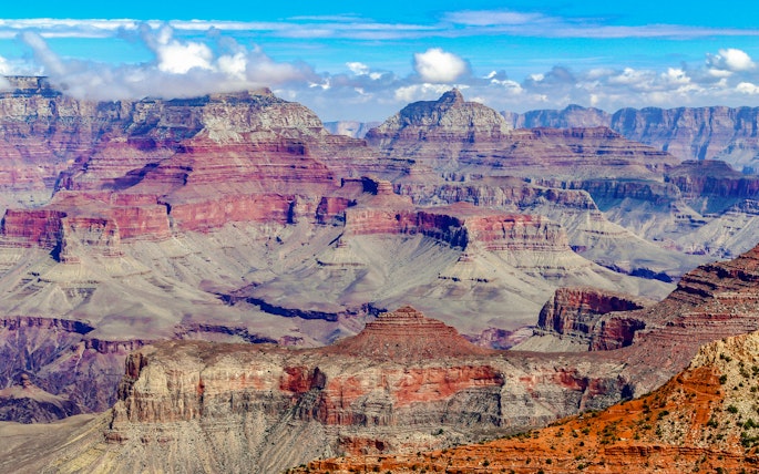 Grand Canyon's layered rock formations under a clear blue sky.