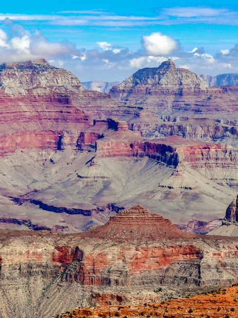 Grand Canyon's layered rock formations under a clear blue sky.